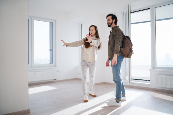 Happy young couple moving and planning in new flat, new home and relocation concept.