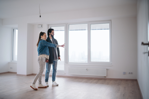 Happy young couple moving in new flat, new home and relocation concept.