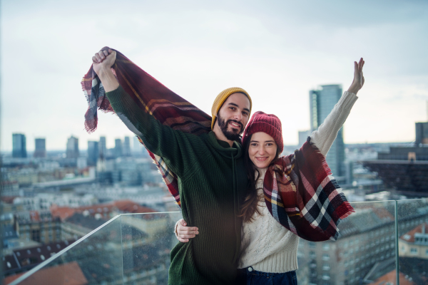 Happy young couple owners on balcony in new flat, moving in, new home and relocation concept.