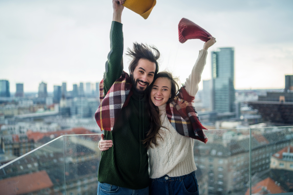 Happy young couple owners on balcony in new flat, moving in, new home and relocation concept.