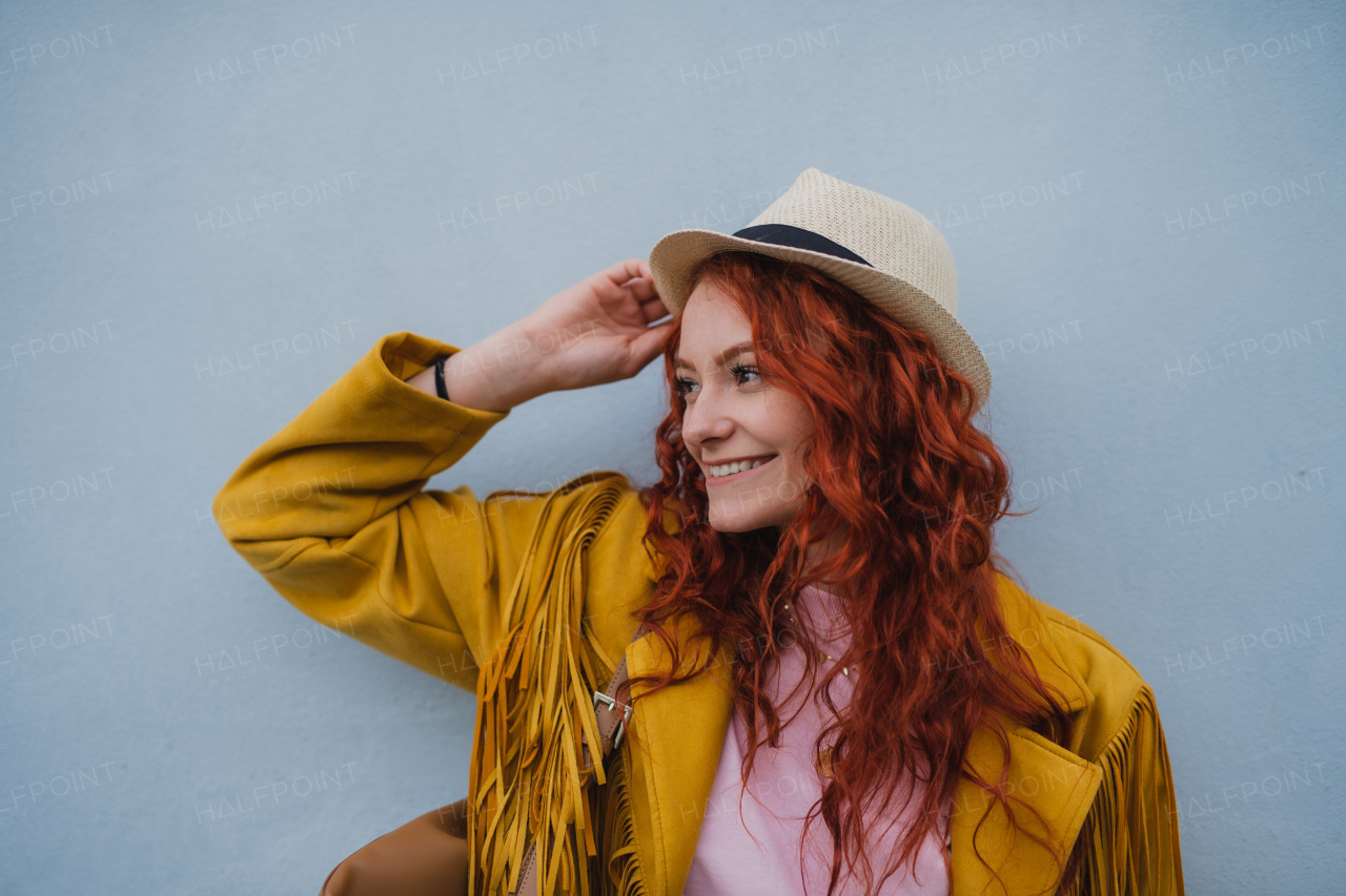 A young woman tourist outdoors against white background on trip in town, looking aside.