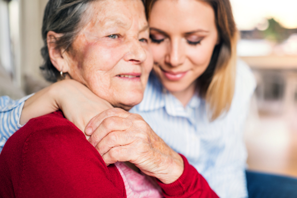 Portrait of an elderly grandmother with an adult granddaughter at home. Close up.