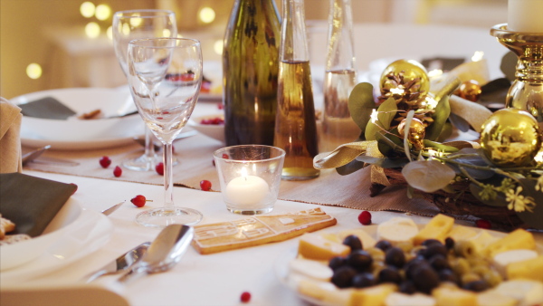 A decorated table set for dinner meal at Christmas time.