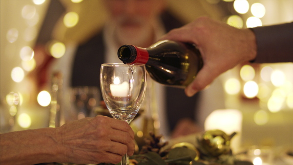 Close-up of wine pouring at the table at Christmas, a dinner concept.