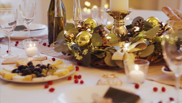 A decorated table set for dinner meal at Christmas time.