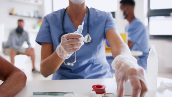 Woman doctor and people getting vaccinated, coronavirus, covid-19 and vaccination concept.