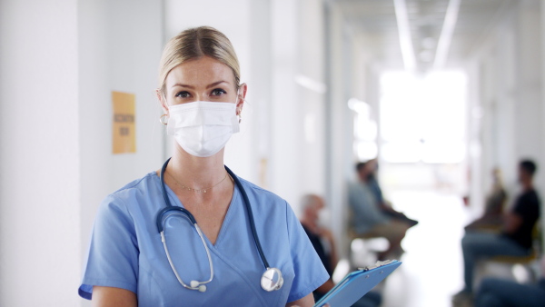 Portrait of doctor and people with face masks, coronavirus, covid-19 and vaccination concept, waiting.