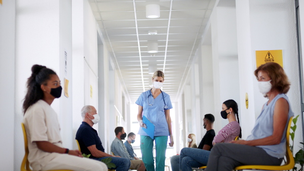 Portrait of doctor and people with face masks, coronavirus, covid-19 and vaccination concept, waiting.