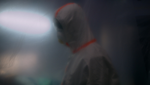 Doctors with protective suits walking in hospital, coronavirus concept.