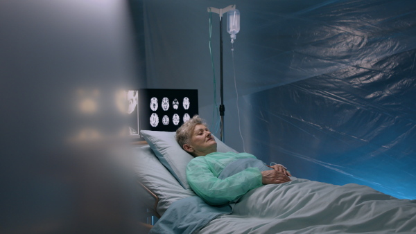 Senior infected patientl lying in bed in hospital, coronavirus concept.