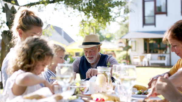 Large family having a big garden party and feasting together.