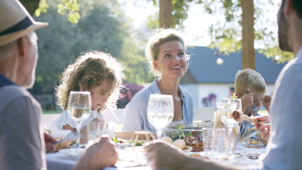 Large family having a big garden party and feasting together.