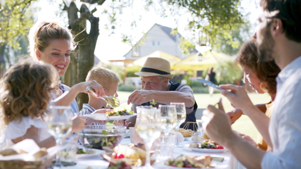 Large family having a big garden party and feasting together.