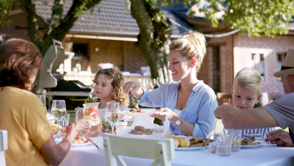 Large family having a big garden party and feasting together.