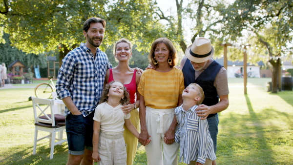 Large family having a garden party and posing for family photo.