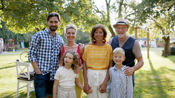 Large family having a garden party and posing for family photo.