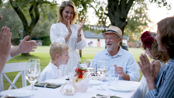 Large family having a big garden party and celebrating grandfathers birthday.