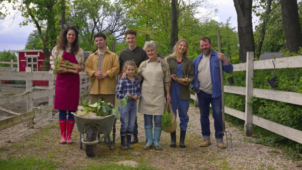 A large group of community farmers standing and looking at camera. Community farming concept.