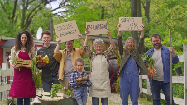 A large group of community farmers protesting with signs. Community farming concept.