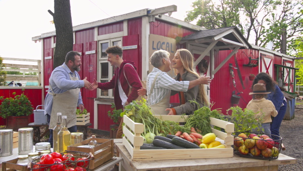 A customers greeting fatmers on farm market. Community farming concept.