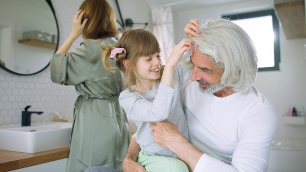 Happy family in bathroom getting ready for day in the morning.