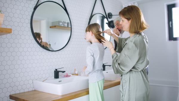 A happy family in bathroom getting ready for day in the morning.