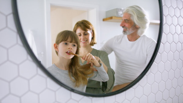 A happy family in bathroom getting ready for day in the morning.