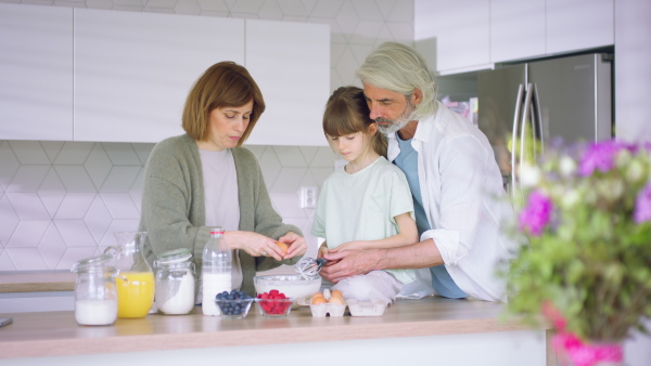 A beautiful family at home preparing a breakfast together.