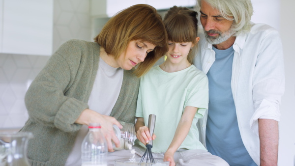 A beautiful family at home preparing a breakfast together.