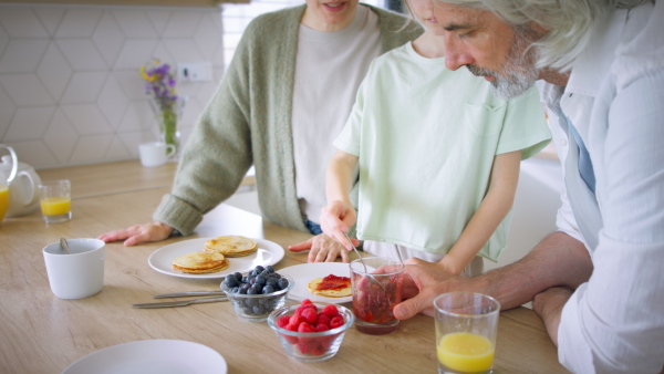 A beautiful family at home having a breakfast together.