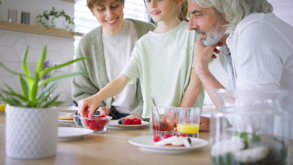 A beautiful family at home having a breakfast together.