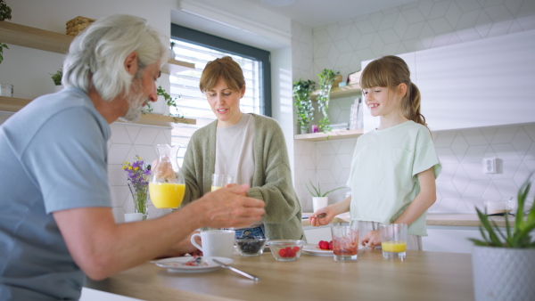 A beautiful family at home having a breakfast together.