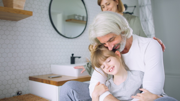 A happy family in bathroom getting ready for day in the morning.