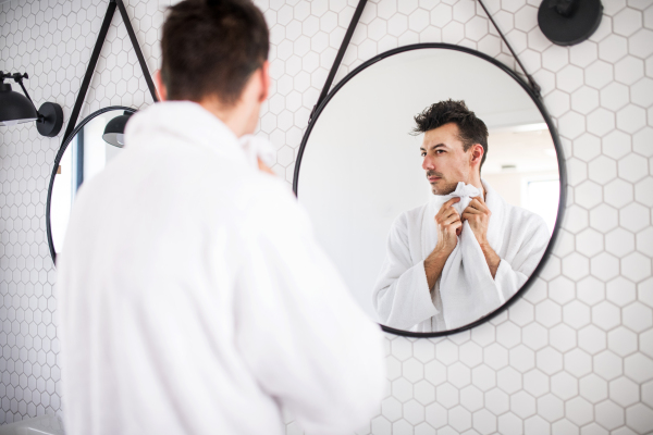 A young man washing in the bathroom in the morning, a daily routine.