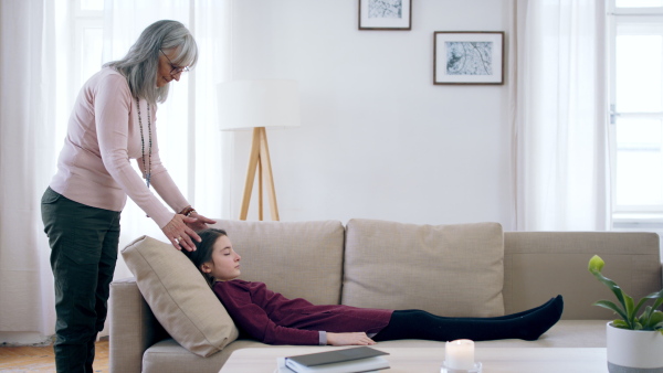 Professional healer doing treatment of small child, mental health concept.