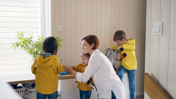 A mother with small children in hall in the morning at home, temper tantrum concept.