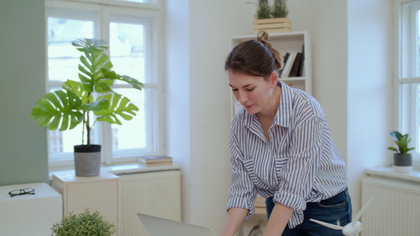 Young businesswoman with laptop working in home office, quarantine concept.