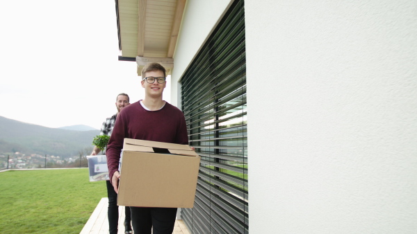 Group of cheerful young people moving in new home, house sharing concept.