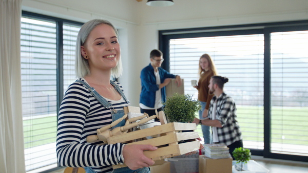 Group of cheerful young people moving in new home, house sharing concept.