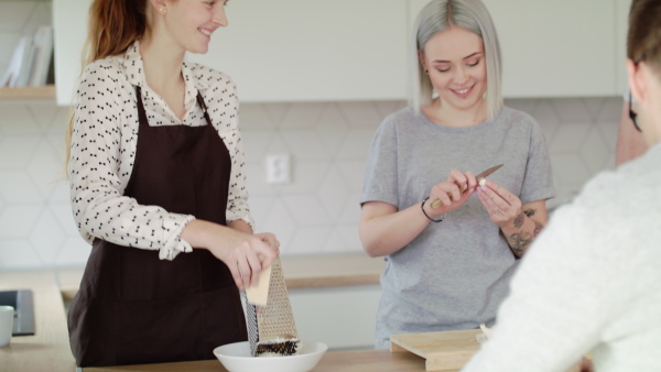 Group of young people cooking together at home, house sharing concept.