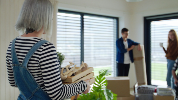 Group of cheerful young people moving in new home, house sharing concept.