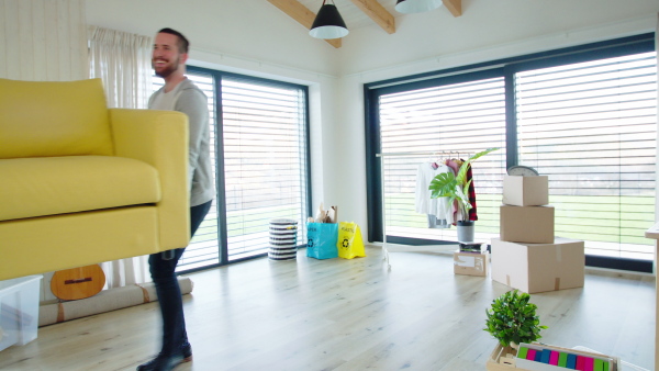 Group of cheerful young people moving in new home, house sharing concept.