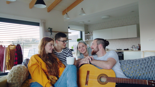 Group of young cheerful people moving in new home, house sharing concept.