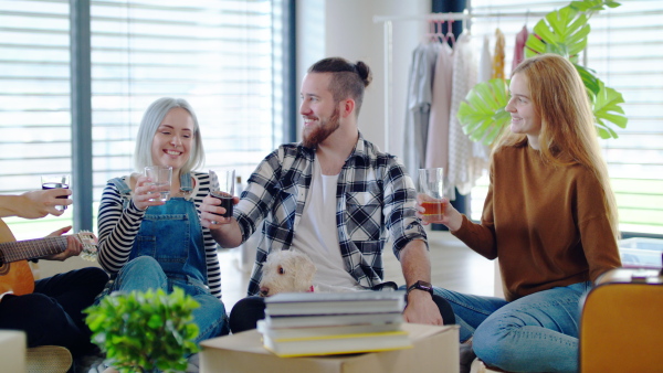 Group of cheerful young people moving in new home, house sharing concept.