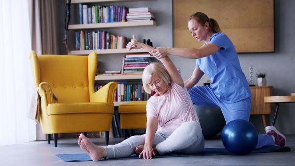 Portrait of senior woman exercising with personal trainer.