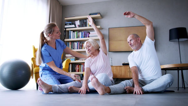 Portrait of senior man exercising with personal trainer.