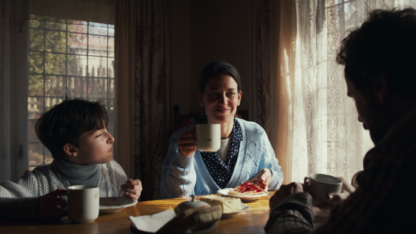 A poor family having a breakfast indoors at home, poverty concept.