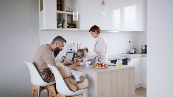 Father working at home, playing with his daughter. Homeoffice concept.