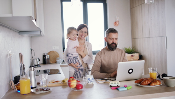 Father working at home, having fun with his family. Homeoffice concept.