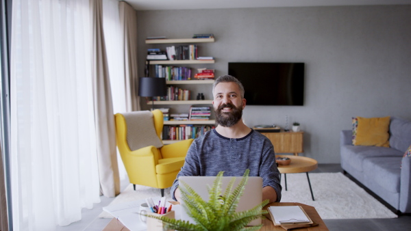 Portrait of a man working at home, looking at camera. Homeoffice concept